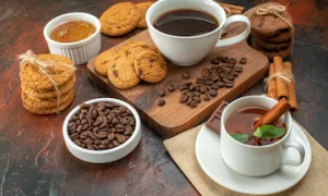 front-view-cup-coffee-with-biscuits-tea-dark-background-cookie-color-morning-breakfast-sugar-cocoa-sweet-tea_461922-25152